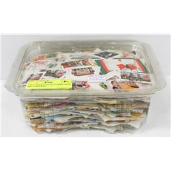 OVER ONE POUND OF STAMPS, MOST ARE CANADIAN.
