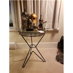 Small round glass topped metal base table & ornaments A