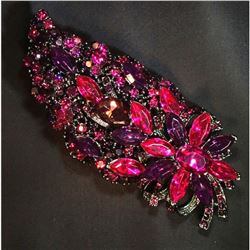 Contemporary violet rhinestone brooch with flower motif.