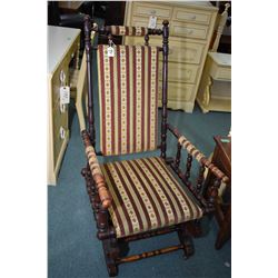 Antique platform rocker with turned supports, original castors and Regency strip upholstery