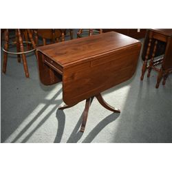 Mid 20th century walnut center pedestal Regency style drop leaf table with single drawer