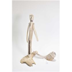 Carved bone articulated sculpture of a male figure 12 1/2" in height and a carved bone bird signed b