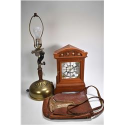 Electrified brass oil lamp, leather satchel with copper decoration and wooden mantle clock, trying t