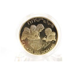 Canadian 1990 non- circulated $100 gold coin portraying an Inuit writing syllabic letters with her c