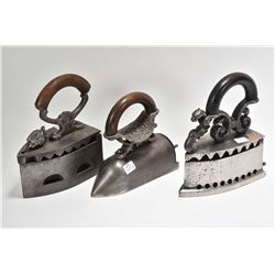 Three antique irons including cast iron charcoal iron with knight motif latch and ornate wood and me