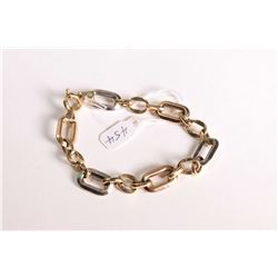 Lady's 18kt yellow and white gold linked chain bracelet 7 1/2" in length, marked 750