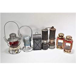 Seven vintage lamps including two miner's lamps, a converted to electric CNR lamp, a pair of coach s