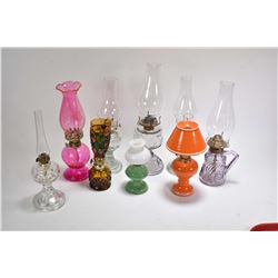 Selection of diminuitive glass oil lamps including finger lamps, some turning purple, lamps with sha