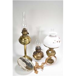 Three vintage brass oil lamps including Bradley and Hubbard with hand painted floral milk glass shad