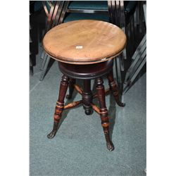 Antique adjustable piano stool with metal cast feet