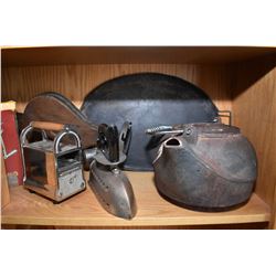 Shelf lot of collectibles including cast iron kettles, sadirons, bellows, Griswald muffin tin, corn 