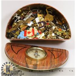 CLOCK TIN WITH APPROX. 200 PINS. CLOCK WORKS