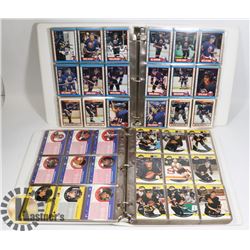 2 BINDERS OF ASSORTED HOCKEY CARDS.