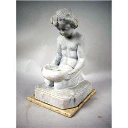 A CARVED MARBLE SCULPTURE OF A KNEELING BOY