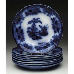 SET OF EIGHT FLOW BLUE PLATES IN THE “C