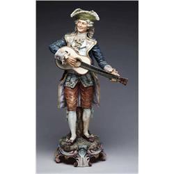 LARGE MAJOLICA FIGURE OF A MAN PLAYING 
