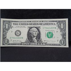 one dollar error bank note with a stack digit error.  The o in the serial number is raised higher th