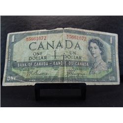 series of 1954 one dollar canadian bank note with the devil's face.  This was an error in printing. 