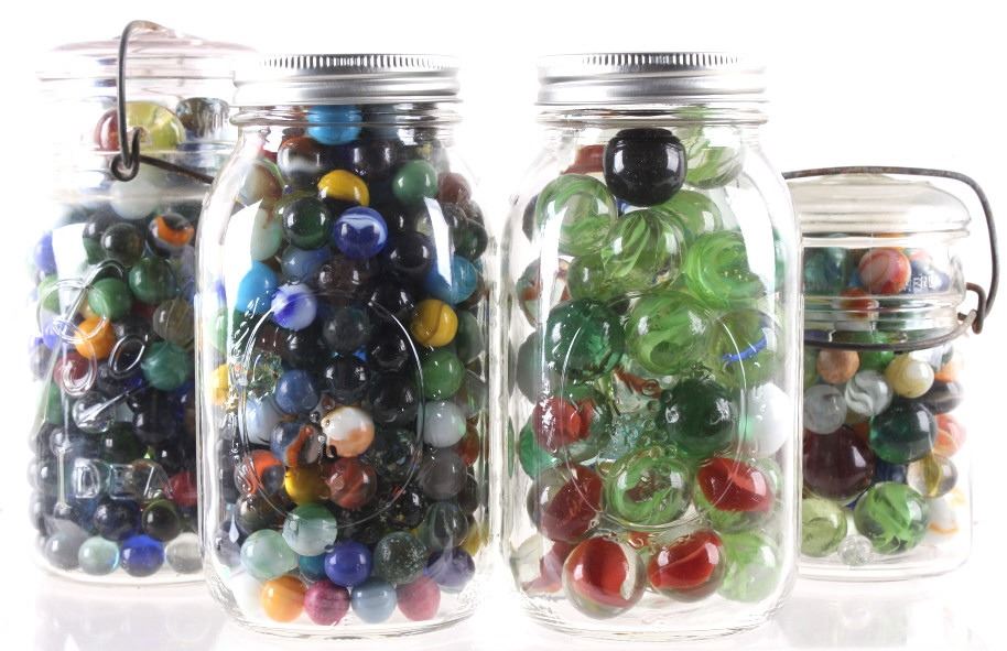 Collection of Various Sized Marbles In Mason Jars