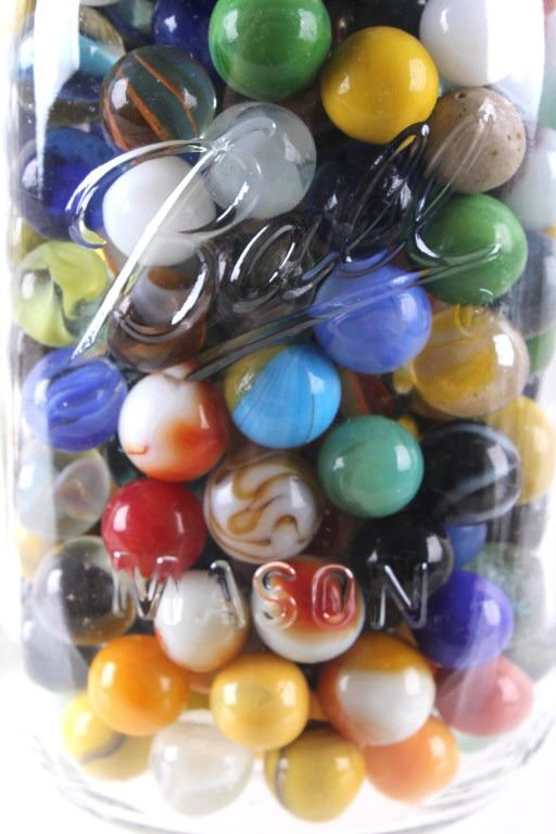 Collection of Various Sized Marbles In Mason Jars
