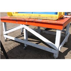 ORANGE WORK TABLE ON CASTORS