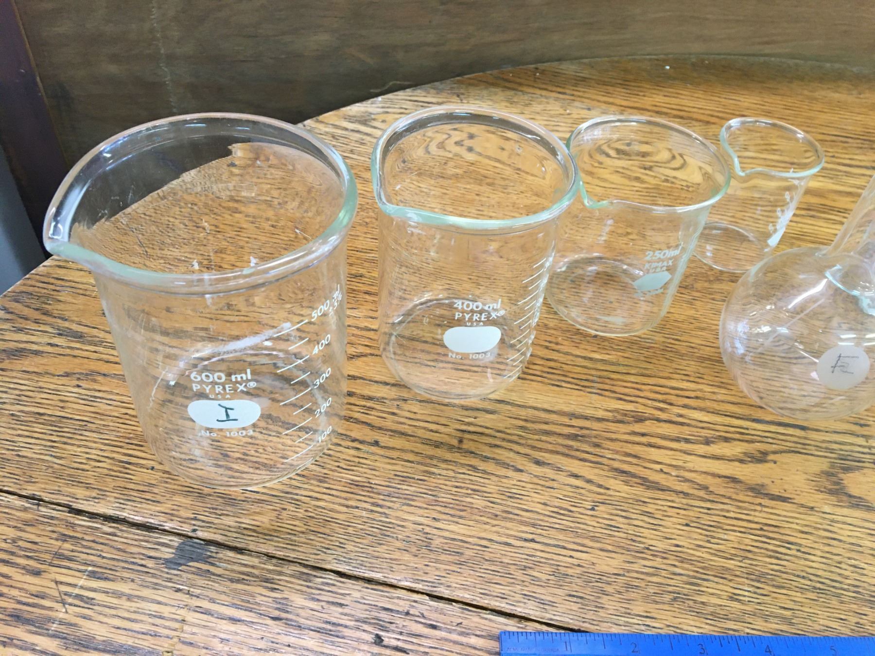 LOT OF SCIENTIFIC MEASURING CUPS BOTTLE AND GLASS TOPS