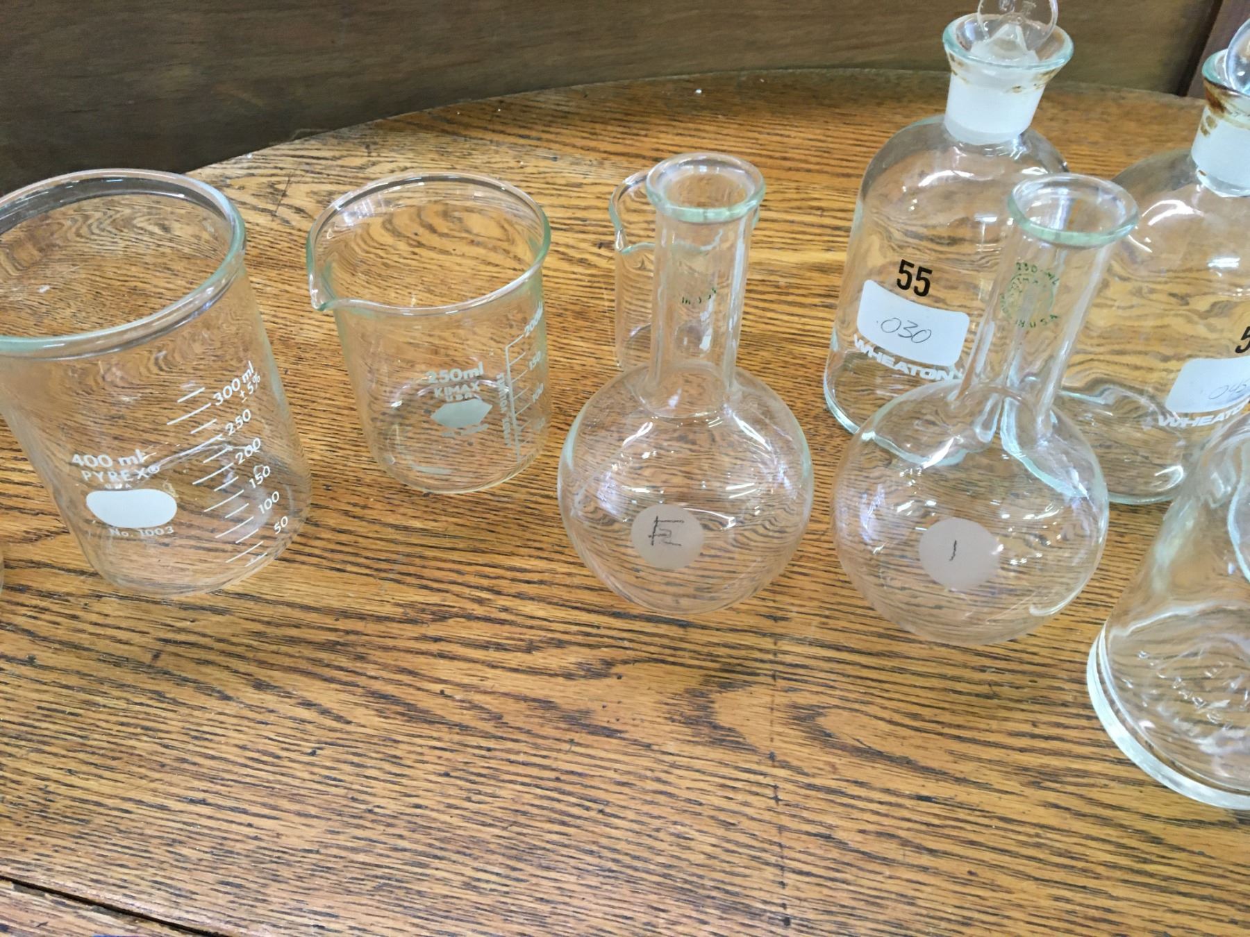 LOT OF SCIENTIFIC MEASURING CUPS BOTTLE AND GLASS TOPS
