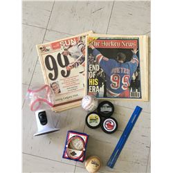 SPORTS RELATED LOT PUCKS BASEBALLS ETC