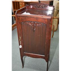 Antique single door music cabinet with attached carved decoration