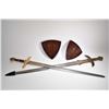 Image 1 : Two decorative broad swords each with serpentine and figural hilt and each with wooden wall mount ha