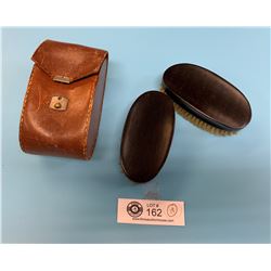 A Pair of Antique Ebony Clothes Brushes in Leather Case