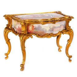 A gilt metal and porcelain jewelry box.