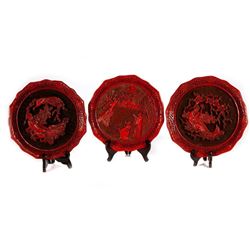 Three commemorative lacquerware plates.