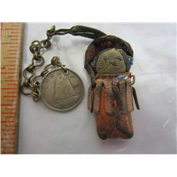 Native good luck charm with 1942 dime attached