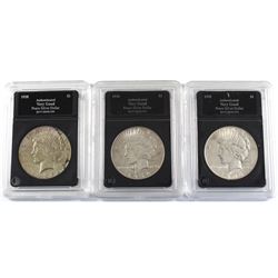 Group Lot 3x USA Silver Peace Dollars. Lot includes: 1928-S, 1934, & 1935. Coins come in hard acryli