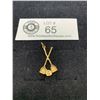 Image 1 : A 10k Gold Curling Charm Pendant