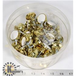 BIN OF BRASS AND WHITE CERAMIC DOOR KNOBS
