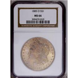 1885-O S$1 MS66 NGC. A thin veneer of golden-tan patin