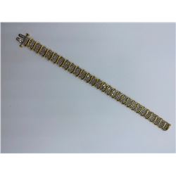 ONE 10KT YELLOW GOLD AND RHODIUM FINISH DIAMOND SET BRACELET.