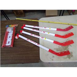 Net and Four Hockey Sticks