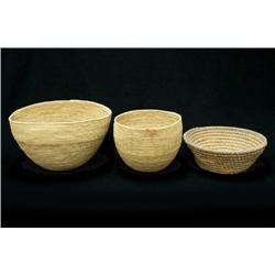 Three baskets including rye straw fille
