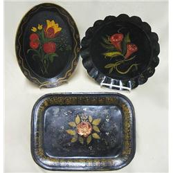 Three toleware trays including oval tra