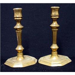 A pair of brass candlesticks; each with