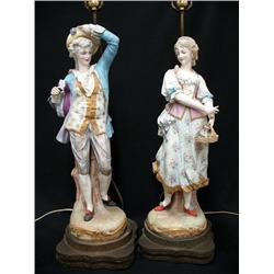 A pair of bisque figural lamps; man hol