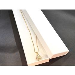 Contemporary golden necklace with clover motif charm.