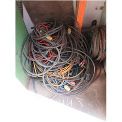 PILE OF EXTENSION CORDS & HOSE IN CORNER