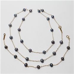 Lady's 10K Yellow Gold Black Pearl Necklace & Bracelet Set. Necklace measures 20" in length, and the