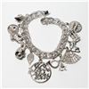 Image 1 : Vintage Sterling Silver Charm Bracelet with 12 Assorted Charms. Weight of 41.89 grams.