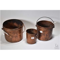 Three graduated antique hand hammered copper pots ranging from 4 1/2 -7 