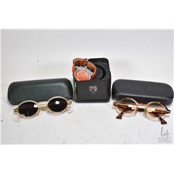 Two pairs of Donna Karan designer sunglasses, both with lighter reader lenses and a Fossil New York 